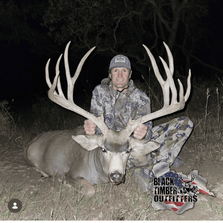 Hunter with a mule deer at night in the Black Timber hunt archive